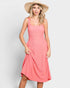 Woman wearing a pink dress and straw hat on a white background
