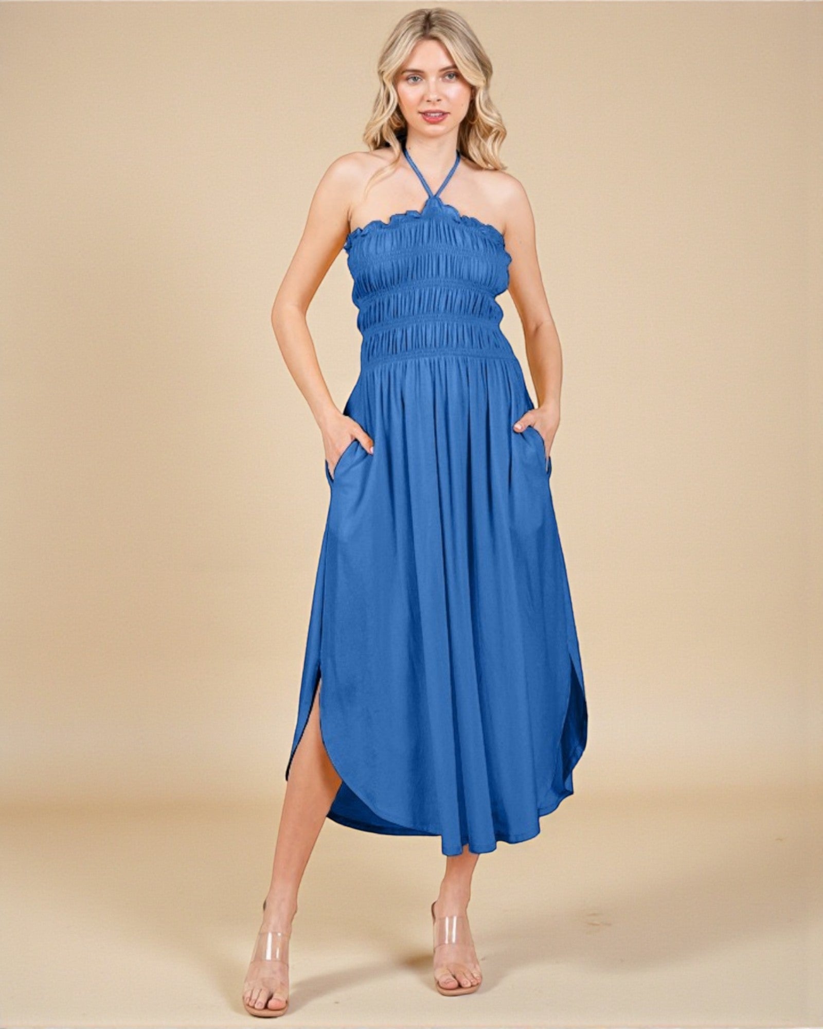 Woman wearing a blue dress with a beige background