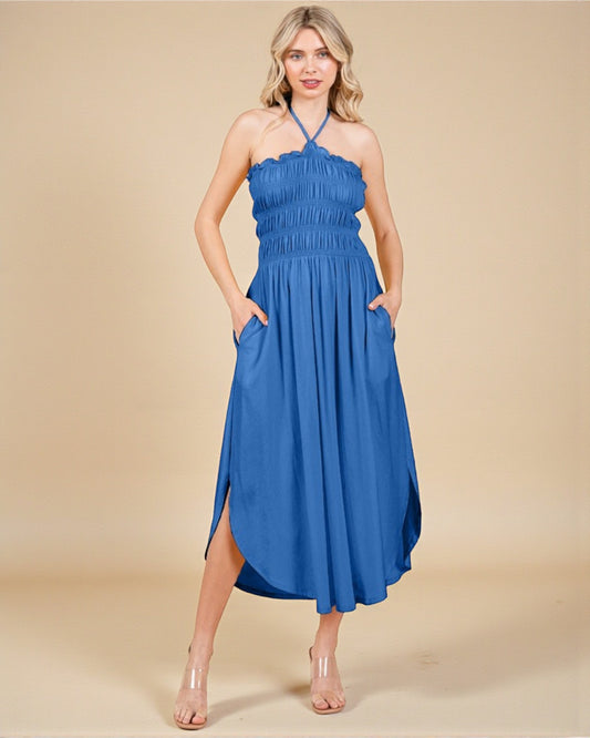 Woman wearing a blue dress with a beige background