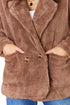 Brown teddy coat with button details on a white background