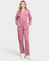Woman wearing a pink jumpsuit on a white background