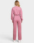 Person wearing a pink jumpsuit on a white background