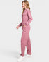 Woman wearing a pink jumpsuit on a white background