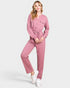 Woman wearing a pink jumpsuit on a white background