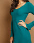 Teal dress worn by a person on a brown background