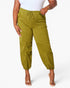A model wearing olive green drawstring jogger pants with side pockets, paired with a white top and clear high-heeled sandals, against a light gray studio background.