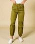 Green cargo pants worn by a person on a beige background