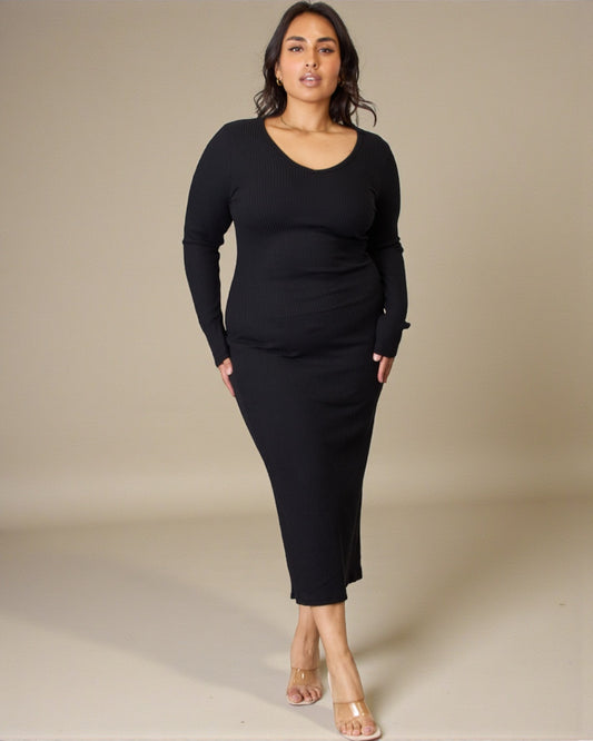 Woman wearing a black outfit against a beige background