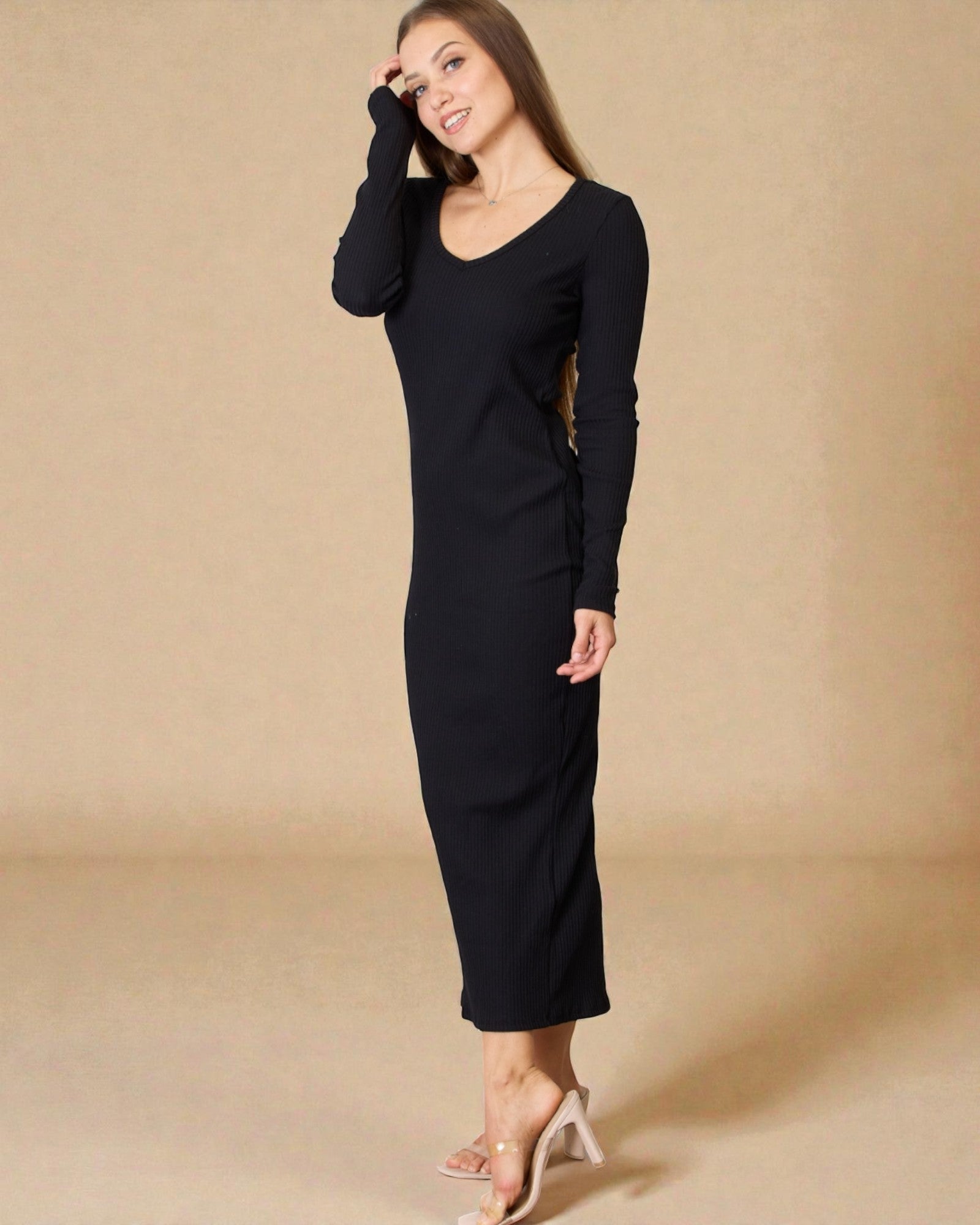 Woman wearing a black dress against a beige background