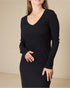 Black ribbed dress worn by a person on a beige background