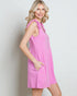 Woman wearing a pink dress against a plain background