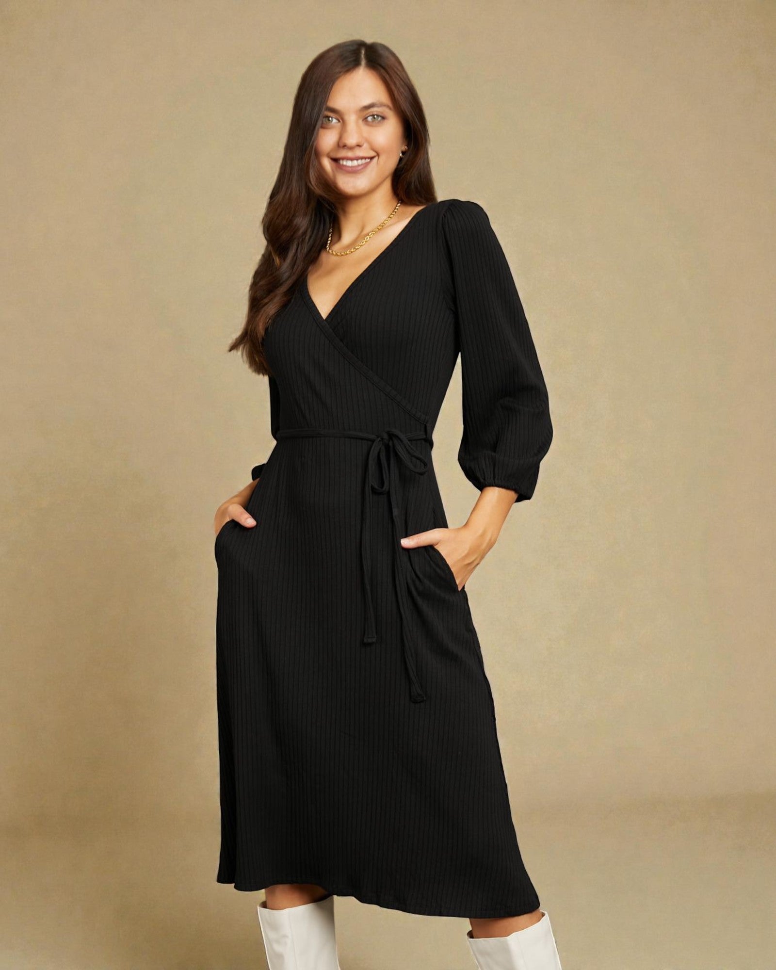 Woman wearing a black dress with white boots against a beige background