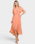 Woman wearing a peach-colored dress on a white background