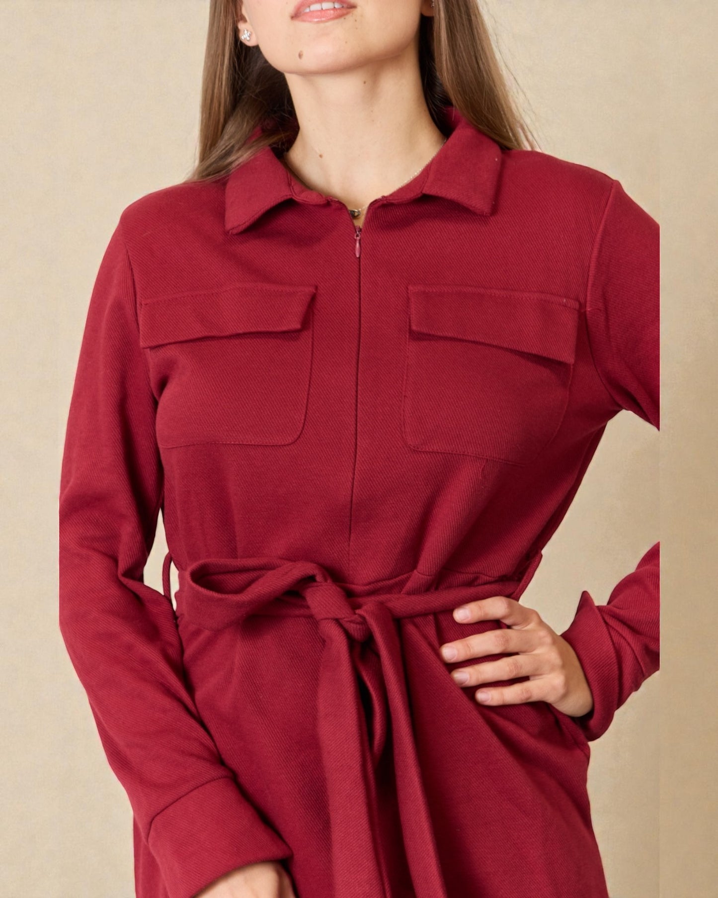 Red dress with a belt on a beige background