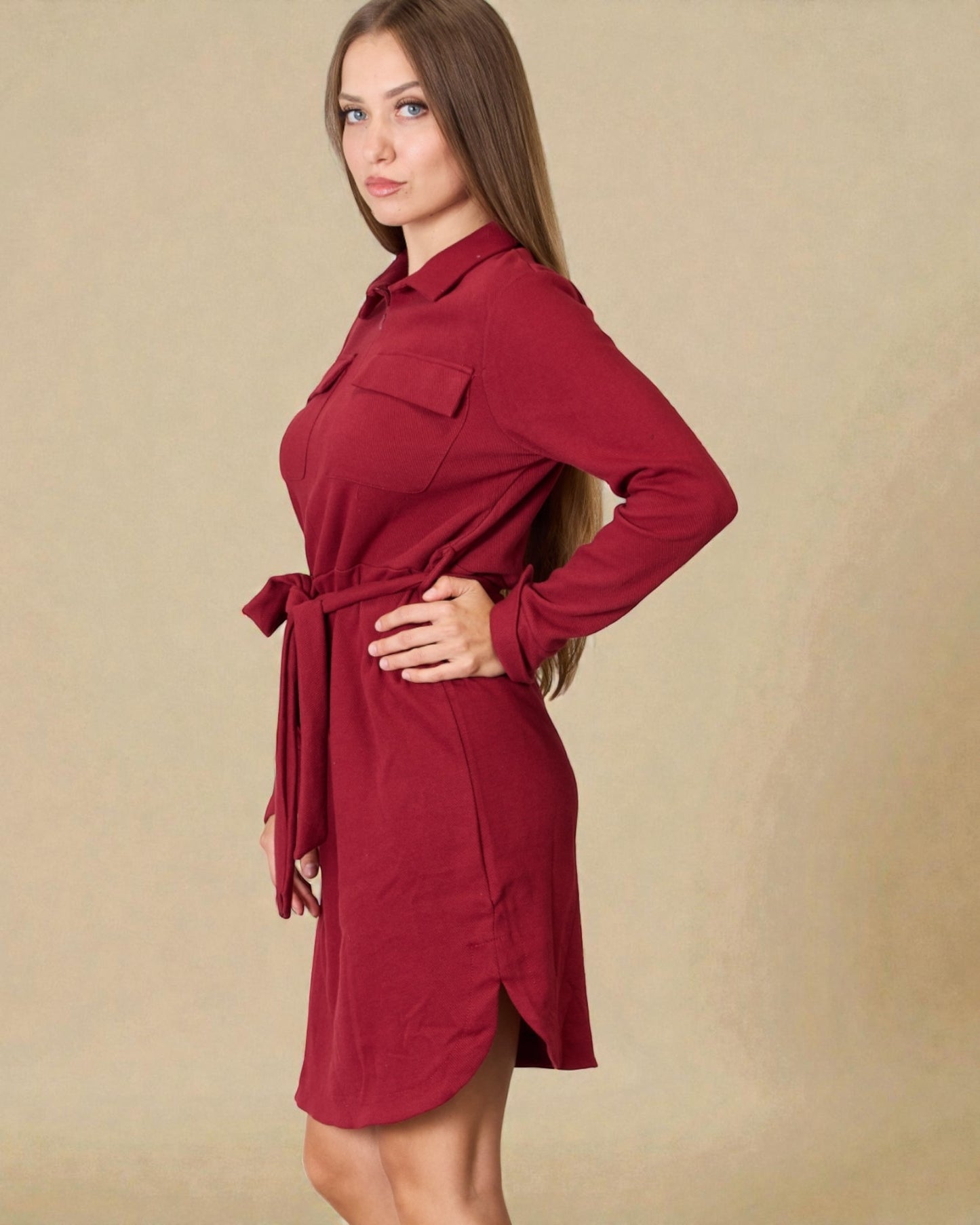 Woman wearing a red dress against a beige background