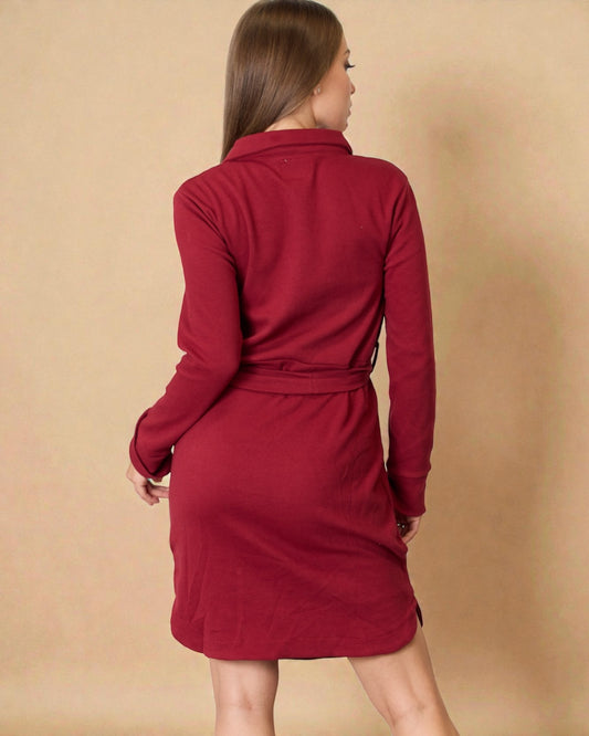 Red dress worn by a person on a beige background