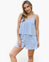 A woman modeling a two-piece camisole and shorts set with a blue and white diagonal stripe pattern, set against a plain white studio background.