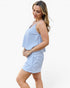 A woman modeling a two-piece matching set consisting of a sleeveless blue and white striped crop top and matching shorts, set against a plain white studio background.