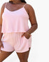 A woman wearing a two-piece camisole and shorts set with a pink and white chevron stripe pattern, shown against a plain white background.