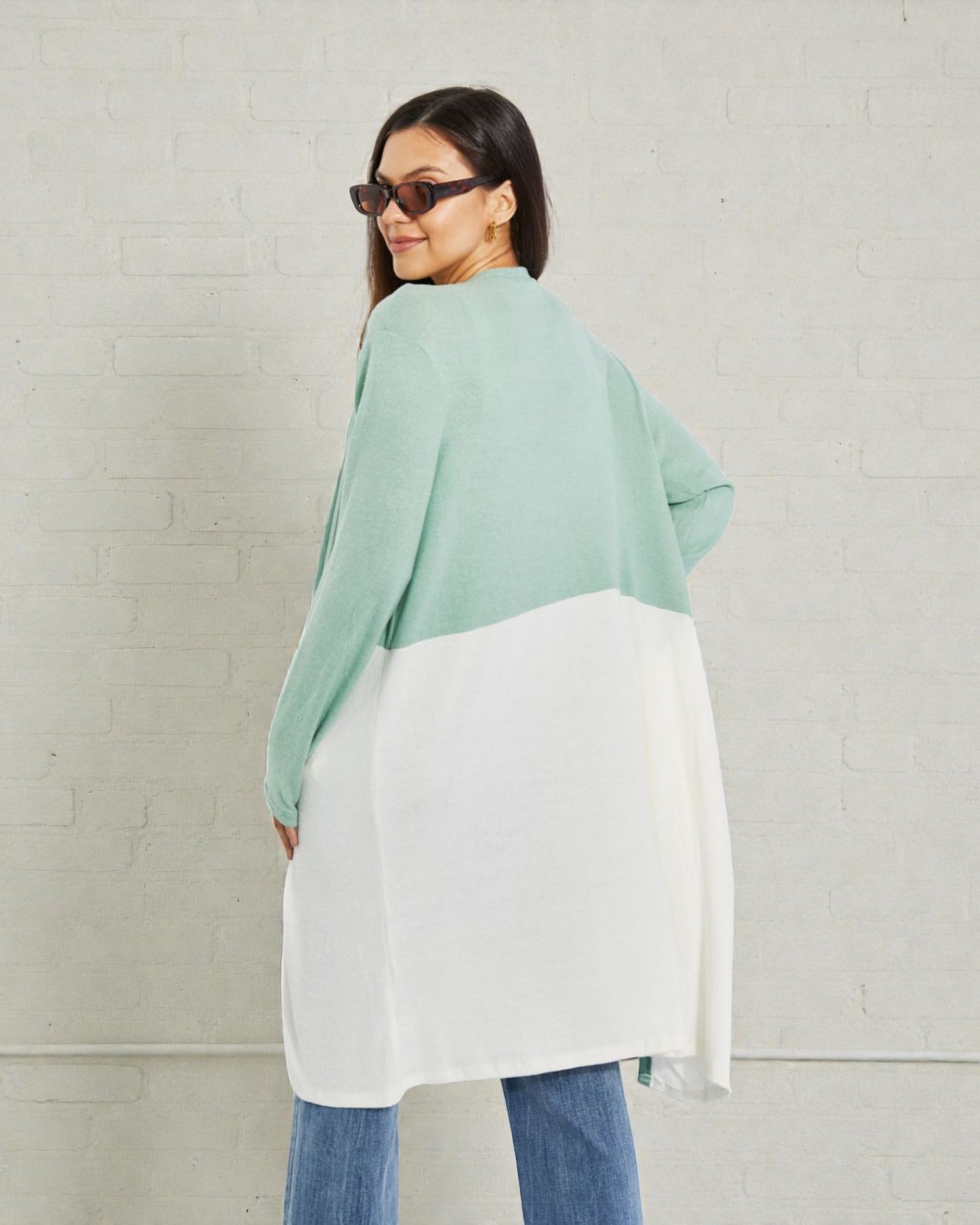 Woman wearing a green and white outfit against a plain background