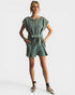 Woman wearing a green dress with a belt on a white background