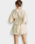 Beige romper worn by a person on a white background