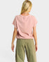 Person wearing a pink top and green pants on a white background