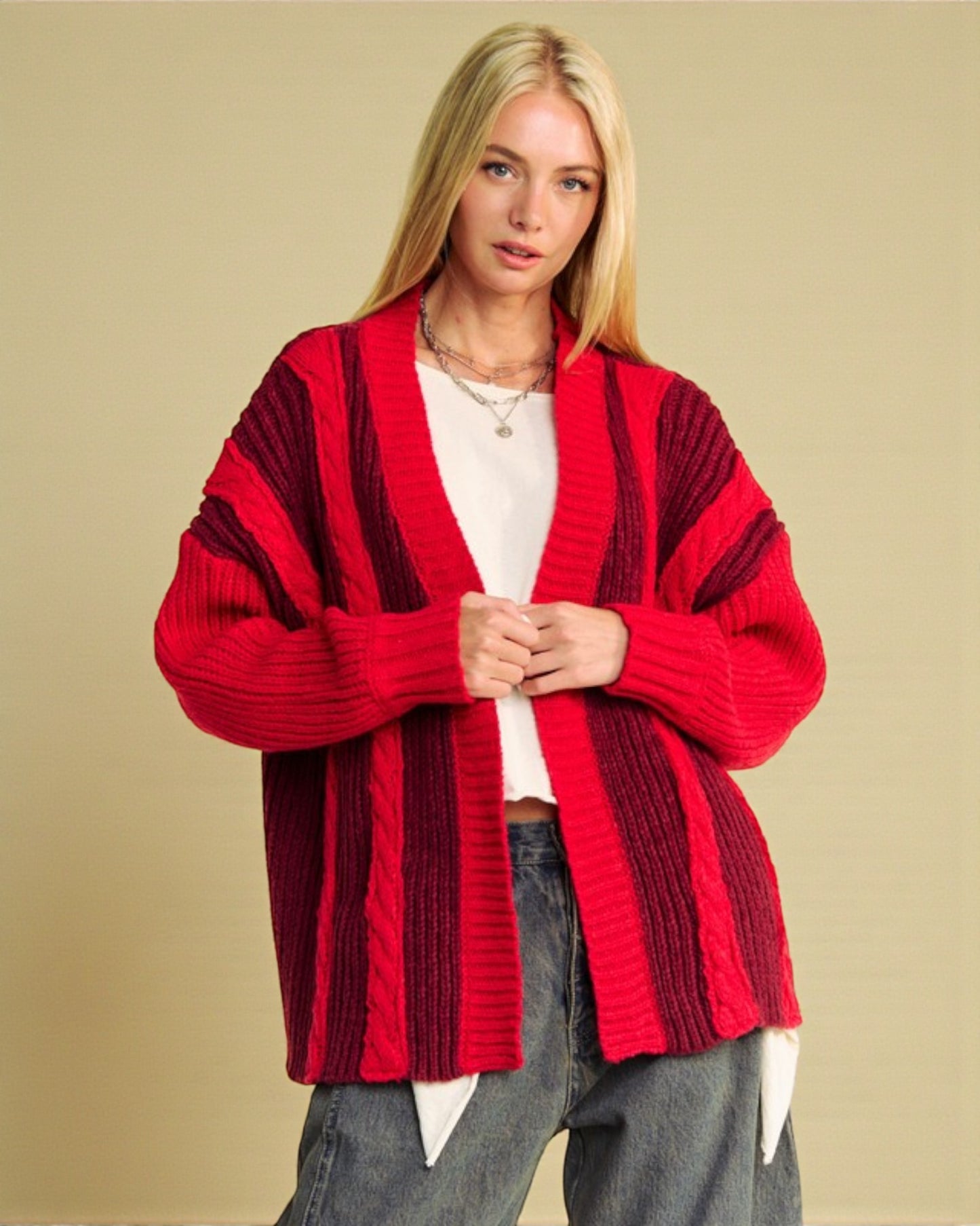 Woman wearing a red striped cardigan against a beige background