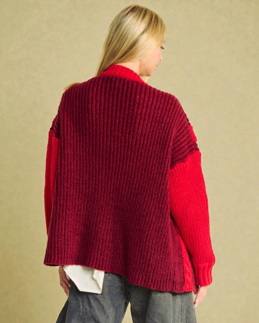 Person wearing a red sweater with a beige background