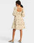 Woman wearing a floral dress with a white background