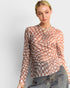 Woman wearing a checkered blouse with a plain background
