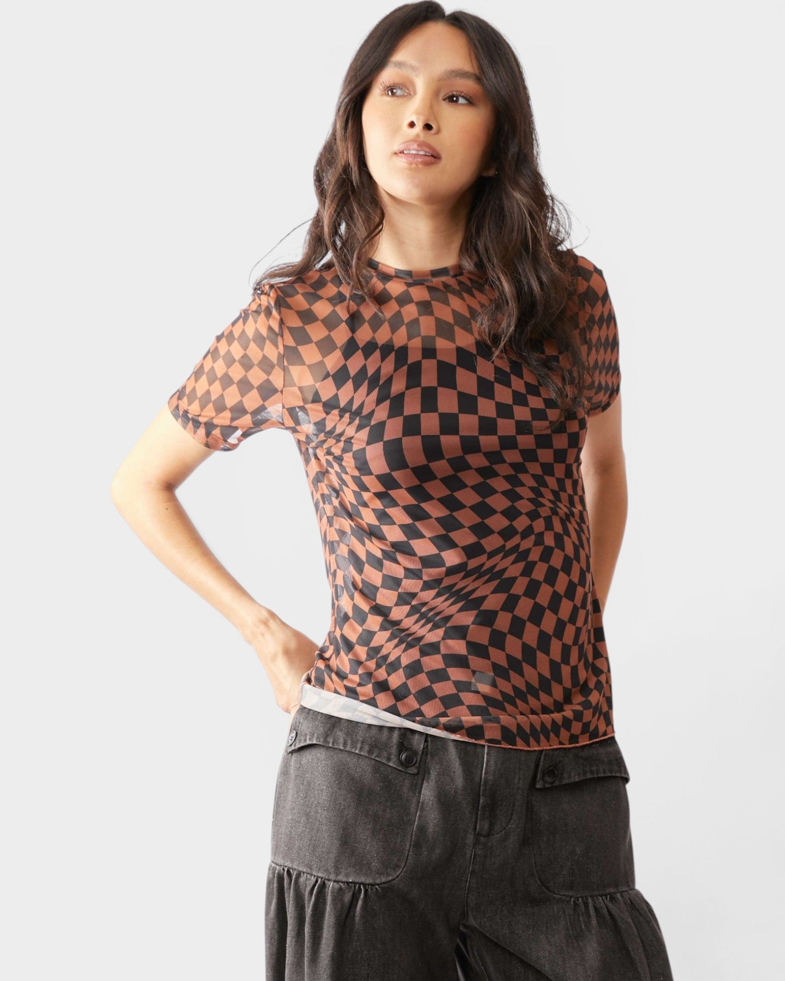 Woman wearing a checkered shirt with a plain background