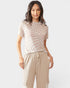Woman wearing a checkered top and beige pants on a white background