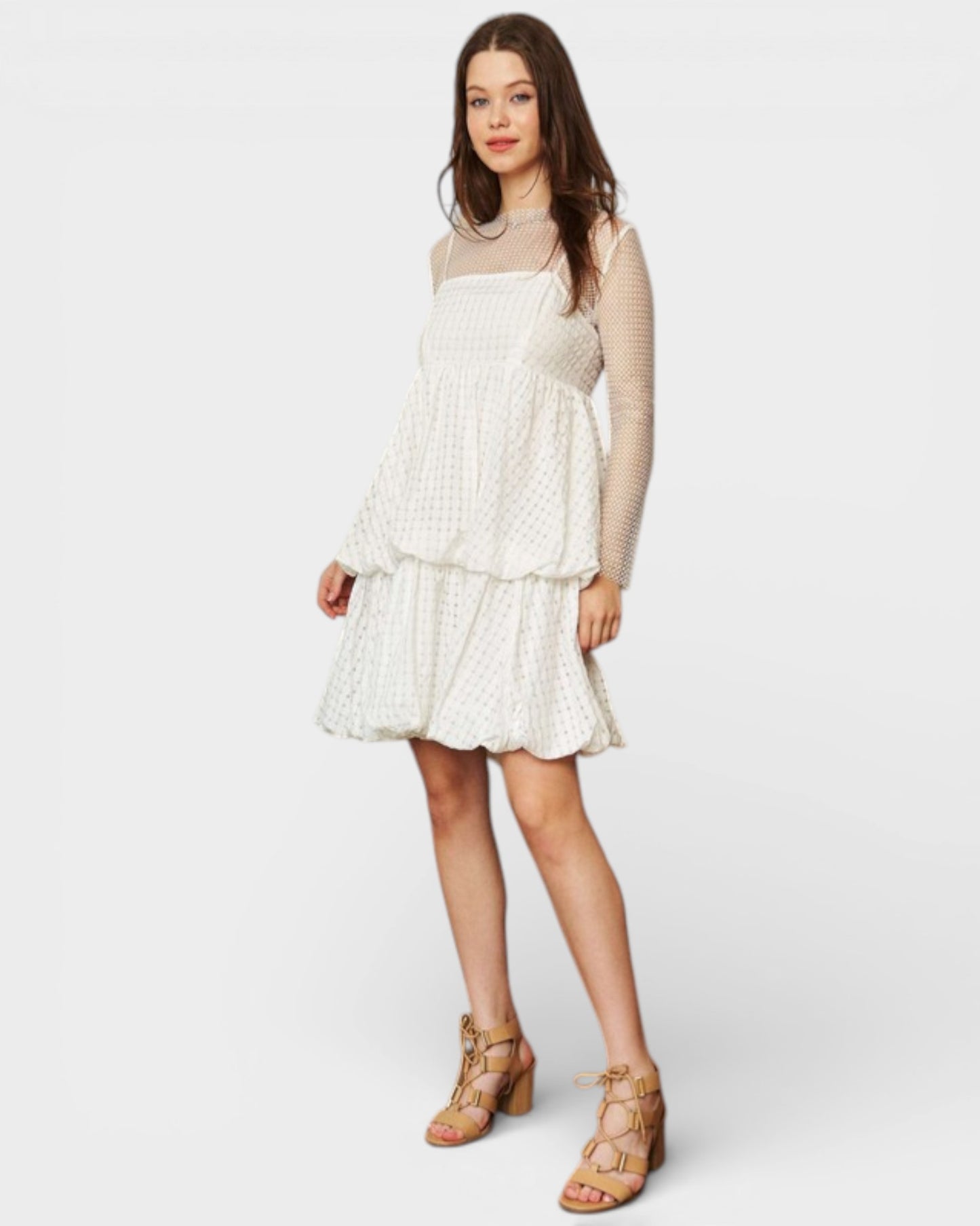 Woman wearing a layered dress with a plain background