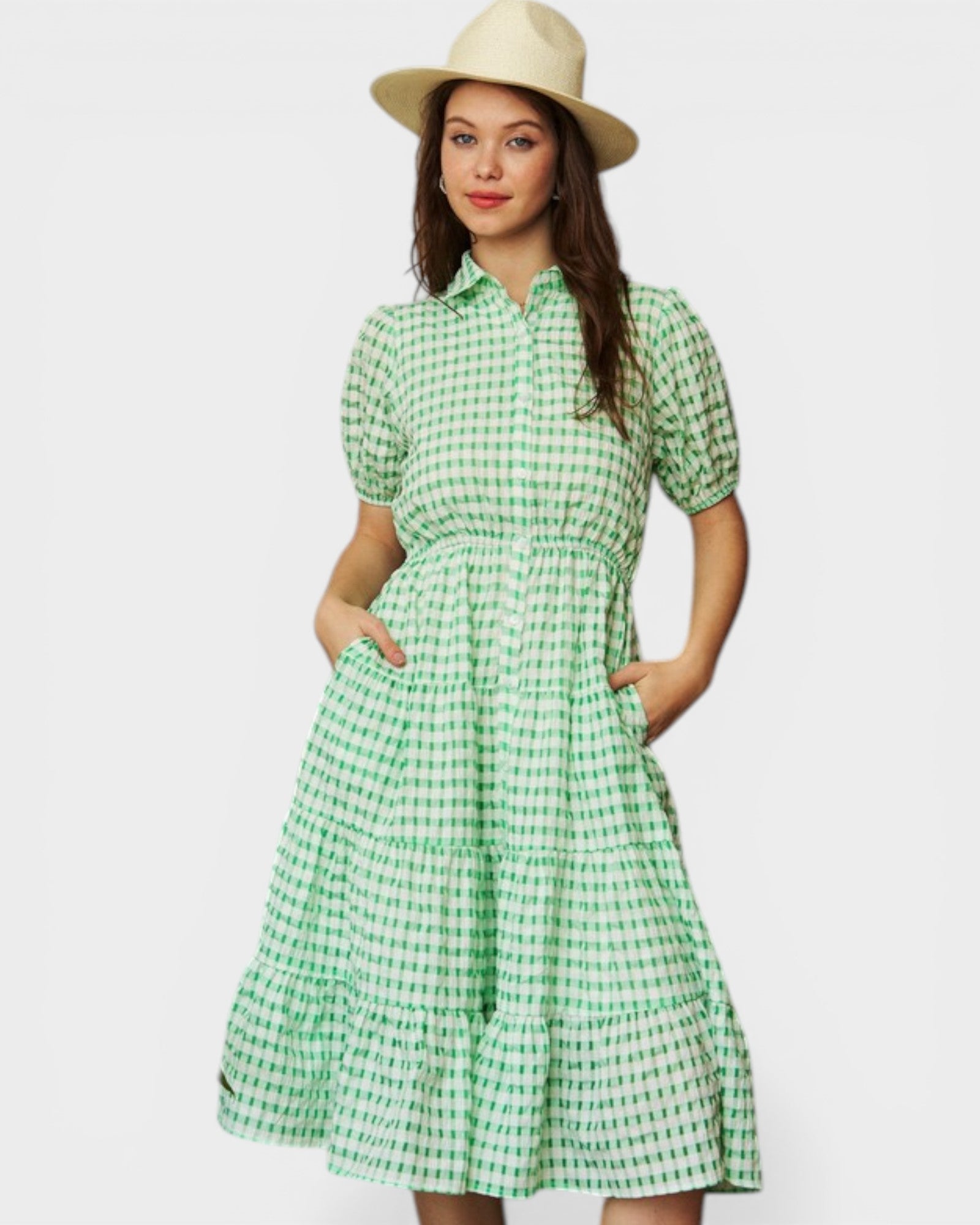 Woman wearing a green checkered dress with a white background