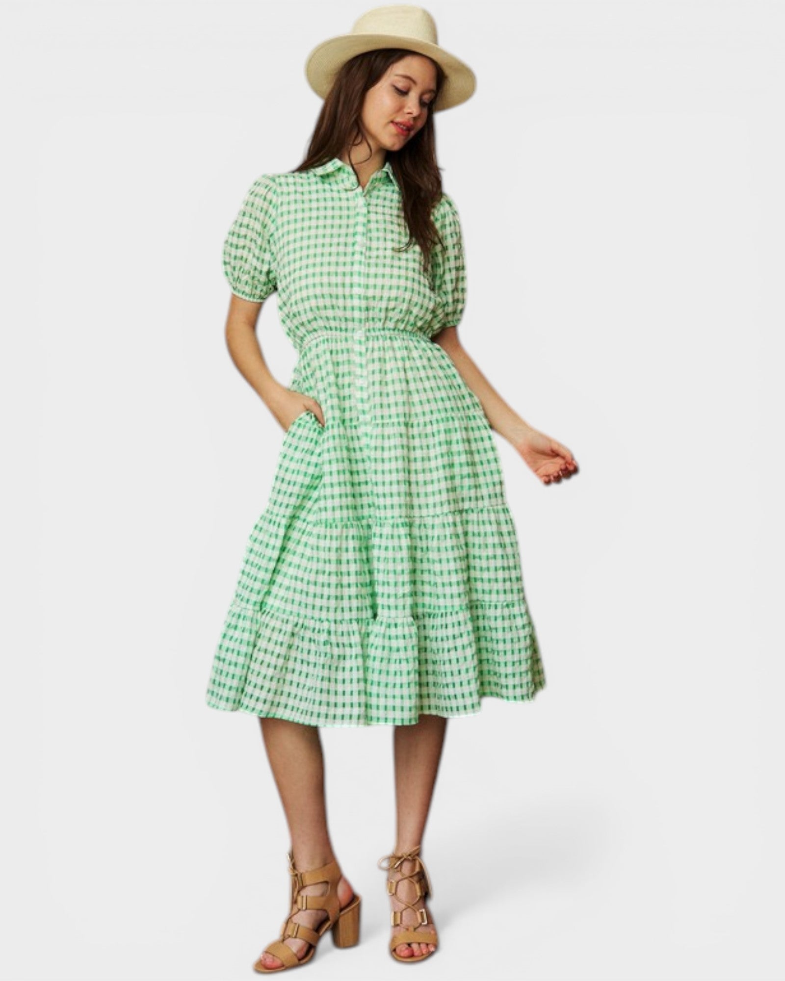Woman wearing a green checkered dress with a white background