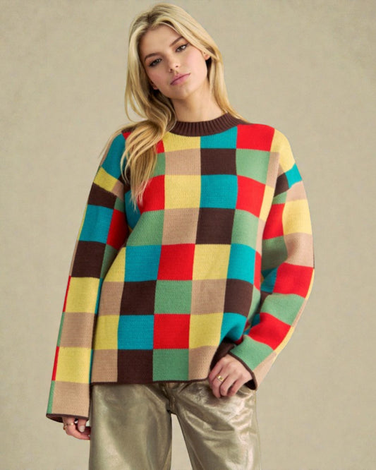 Woman wearing a colorful checkered sweater against a beige background