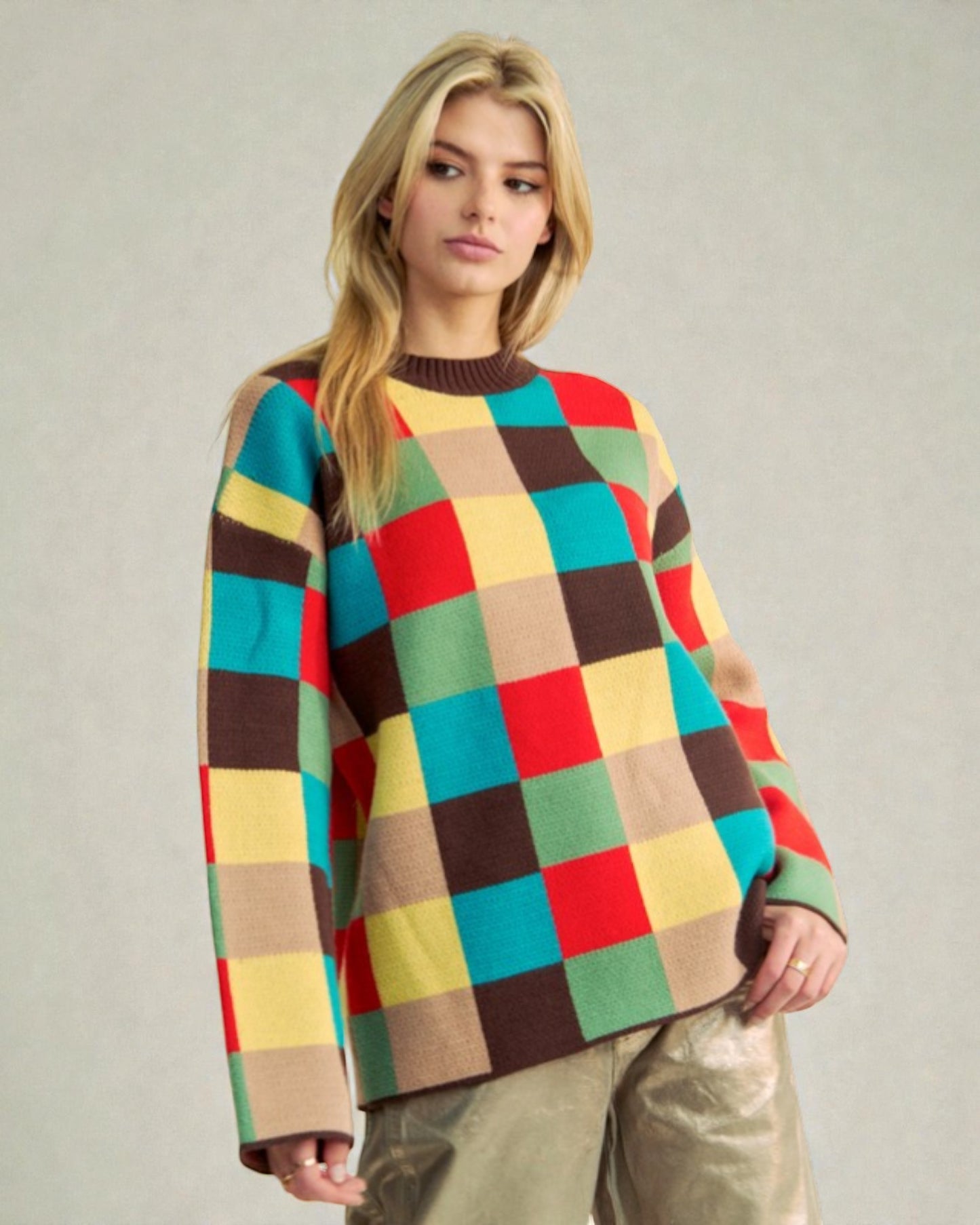 Woman wearing a colorful checkered sweater against a plain background