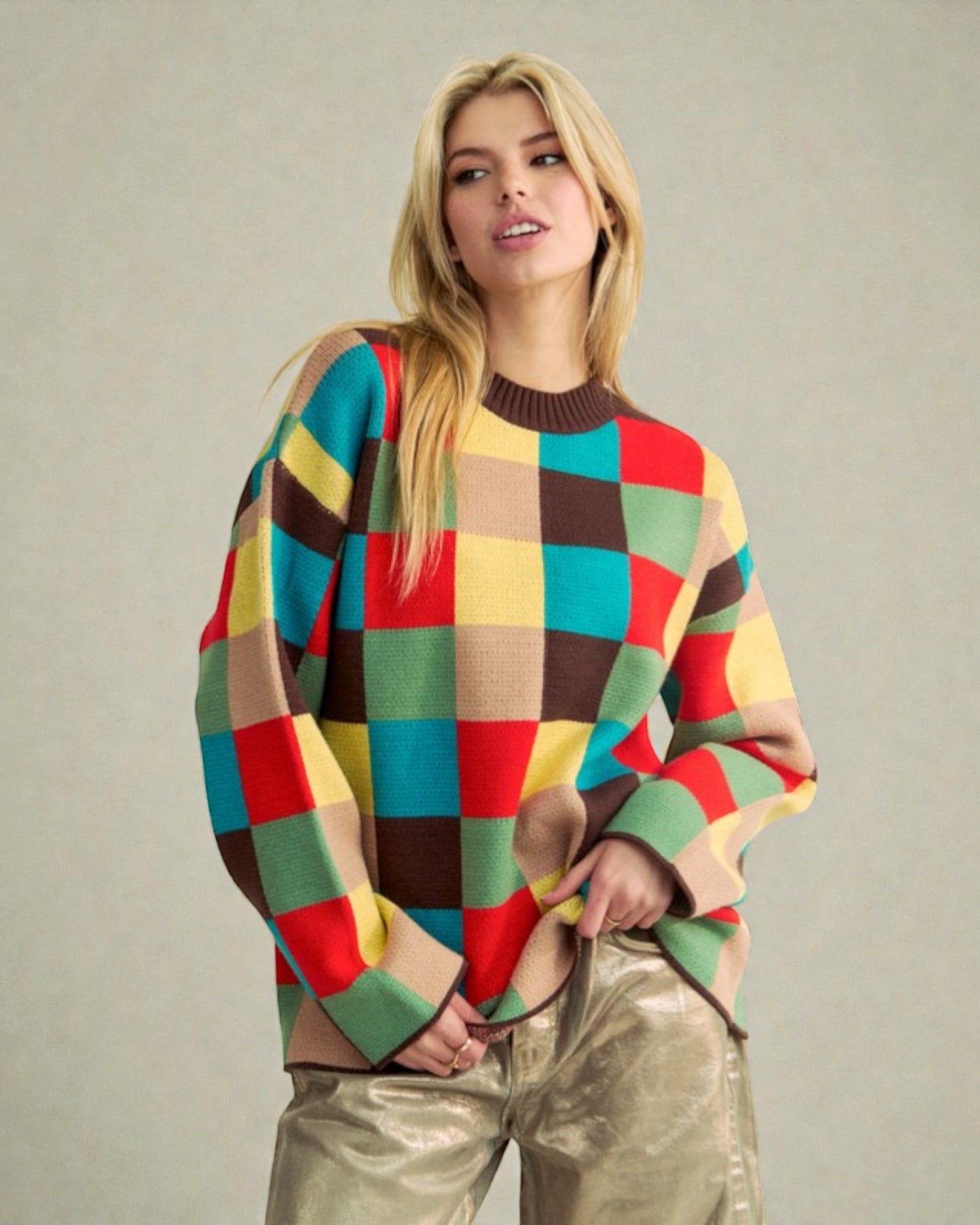 Woman wearing a colorful checkered sweater against a plain background