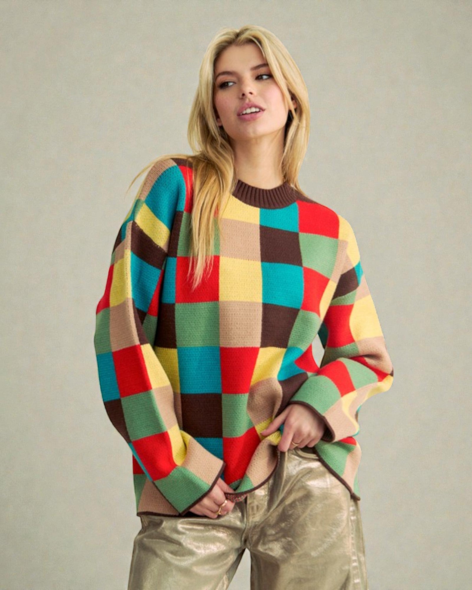Woman wearing a colorful checkered sweater against a plain background
