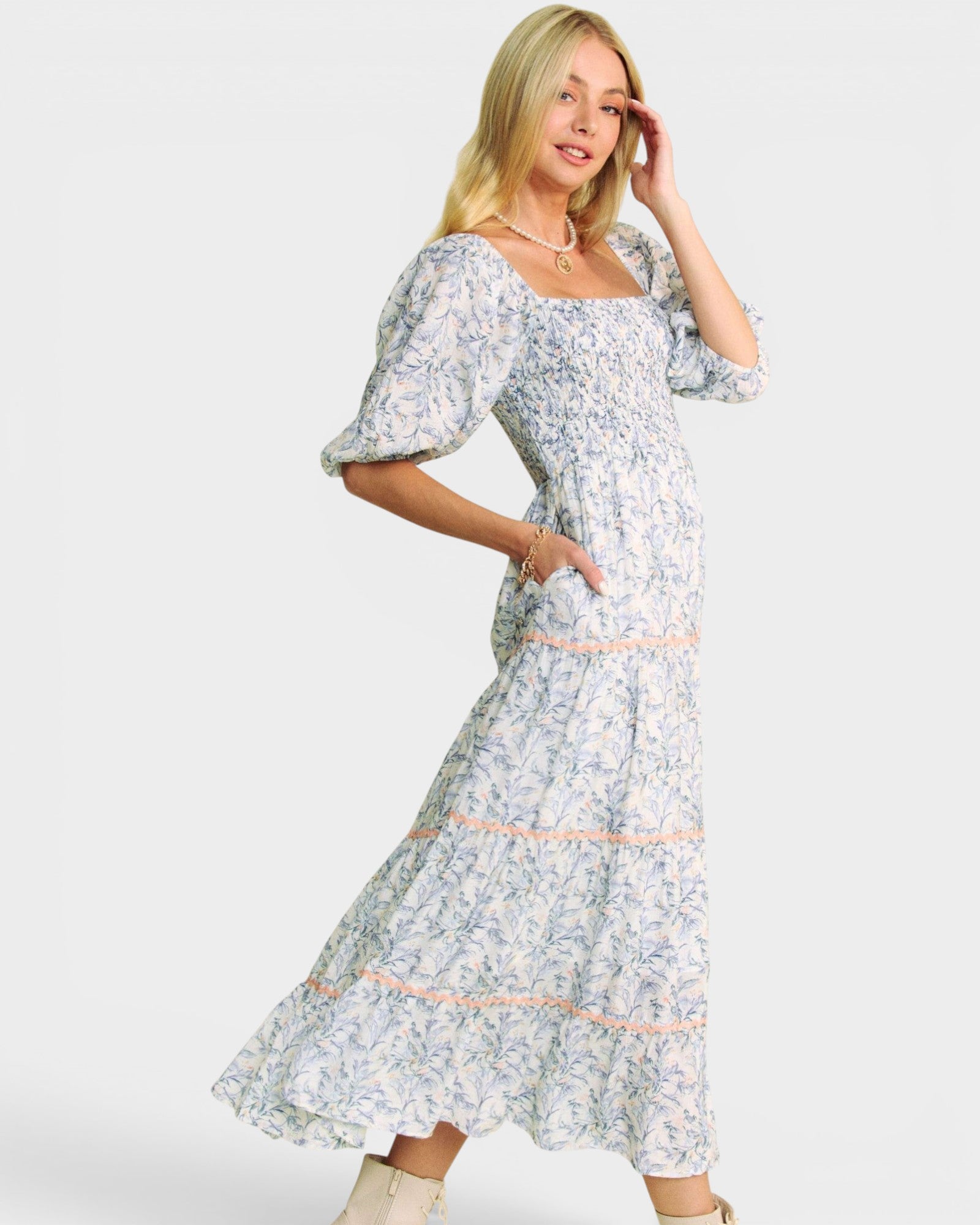 Woman wearing a floral dress on a white background