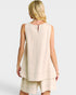 Woman wearing a beige sleeveless top and shorts set on a white background