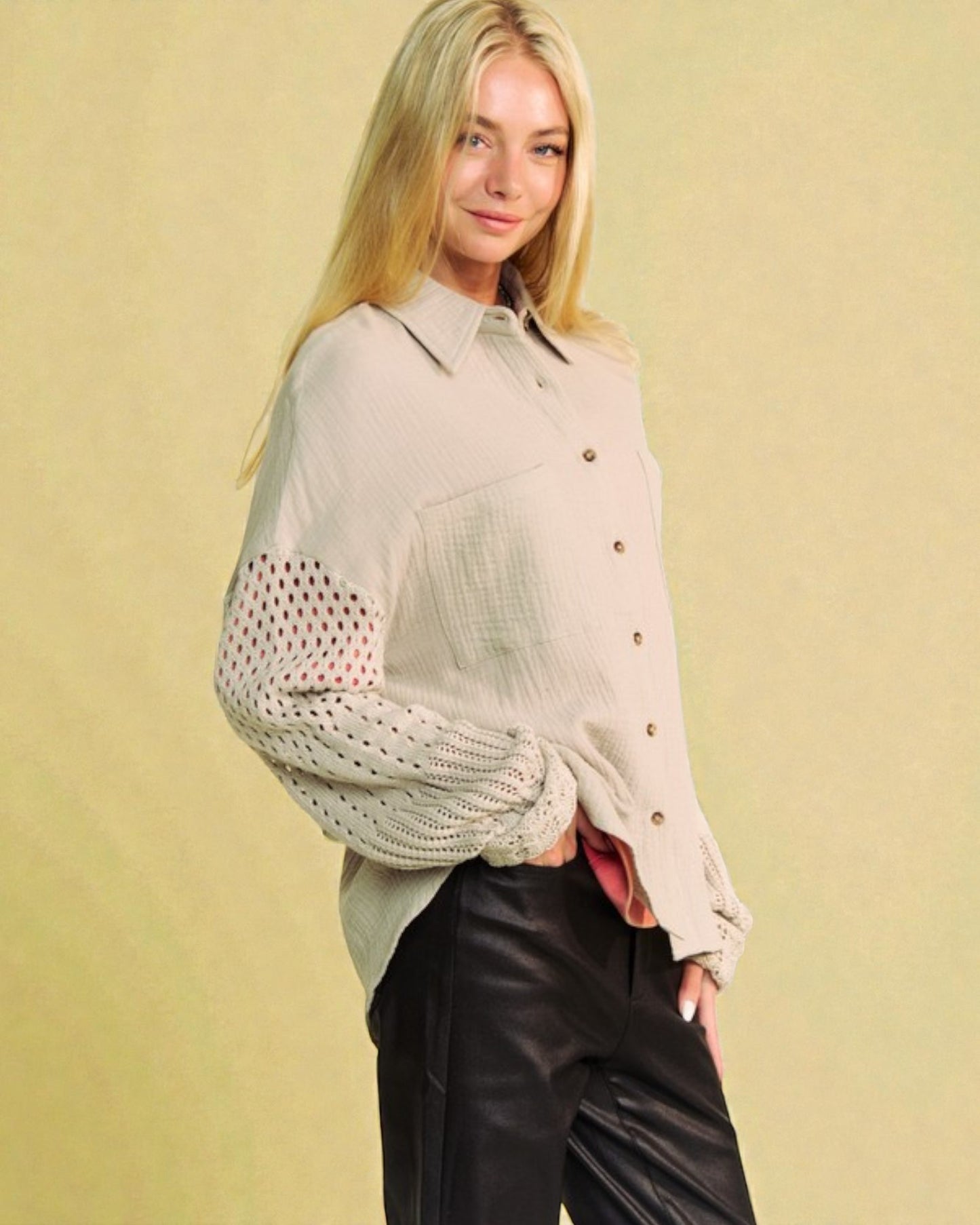 Woman wearing a beige button-up shirt with a polka dot overlay against a beige background