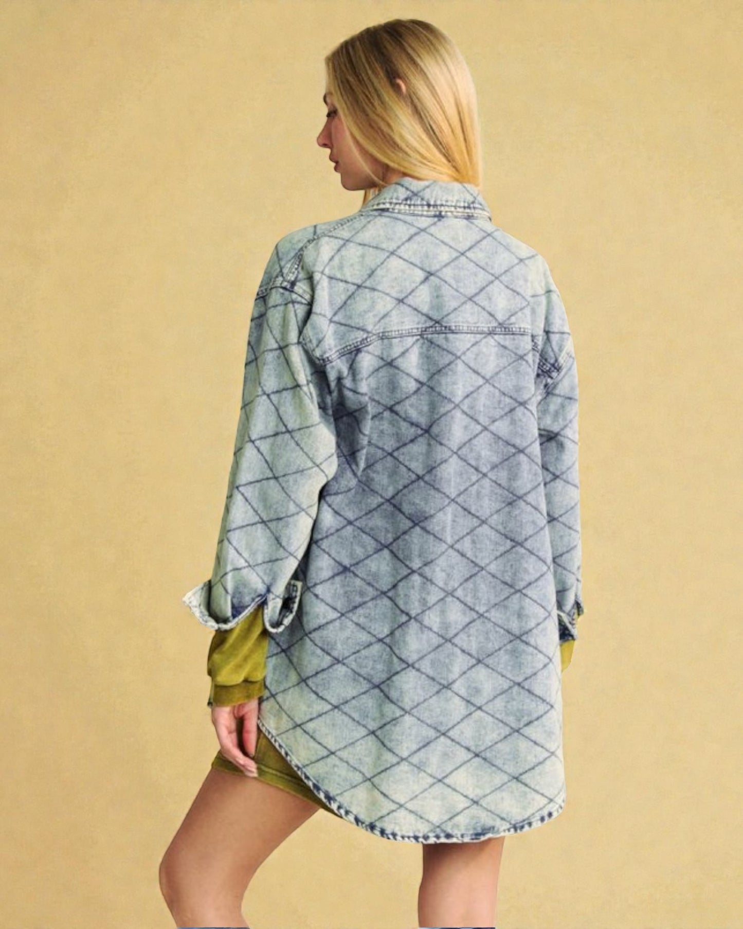 Woman wearing a diamond patterned denim shirt against a beige background