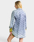 Woman wearing a blue diamond patterned shirt on a white background