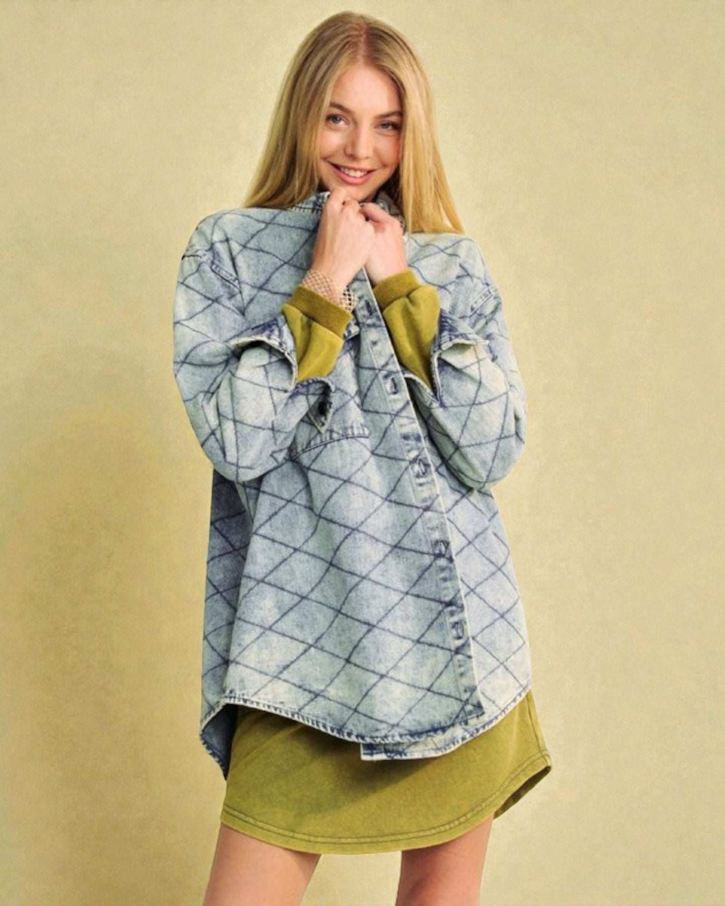 Woman wearing a blue checkered shirt over a green dress on a beige background