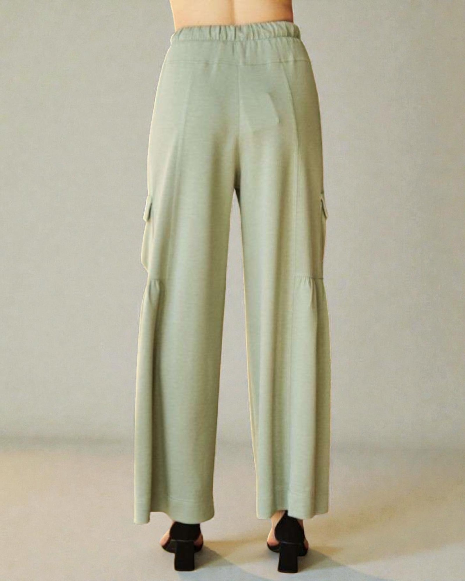 Light green cargo pants on a neutral background