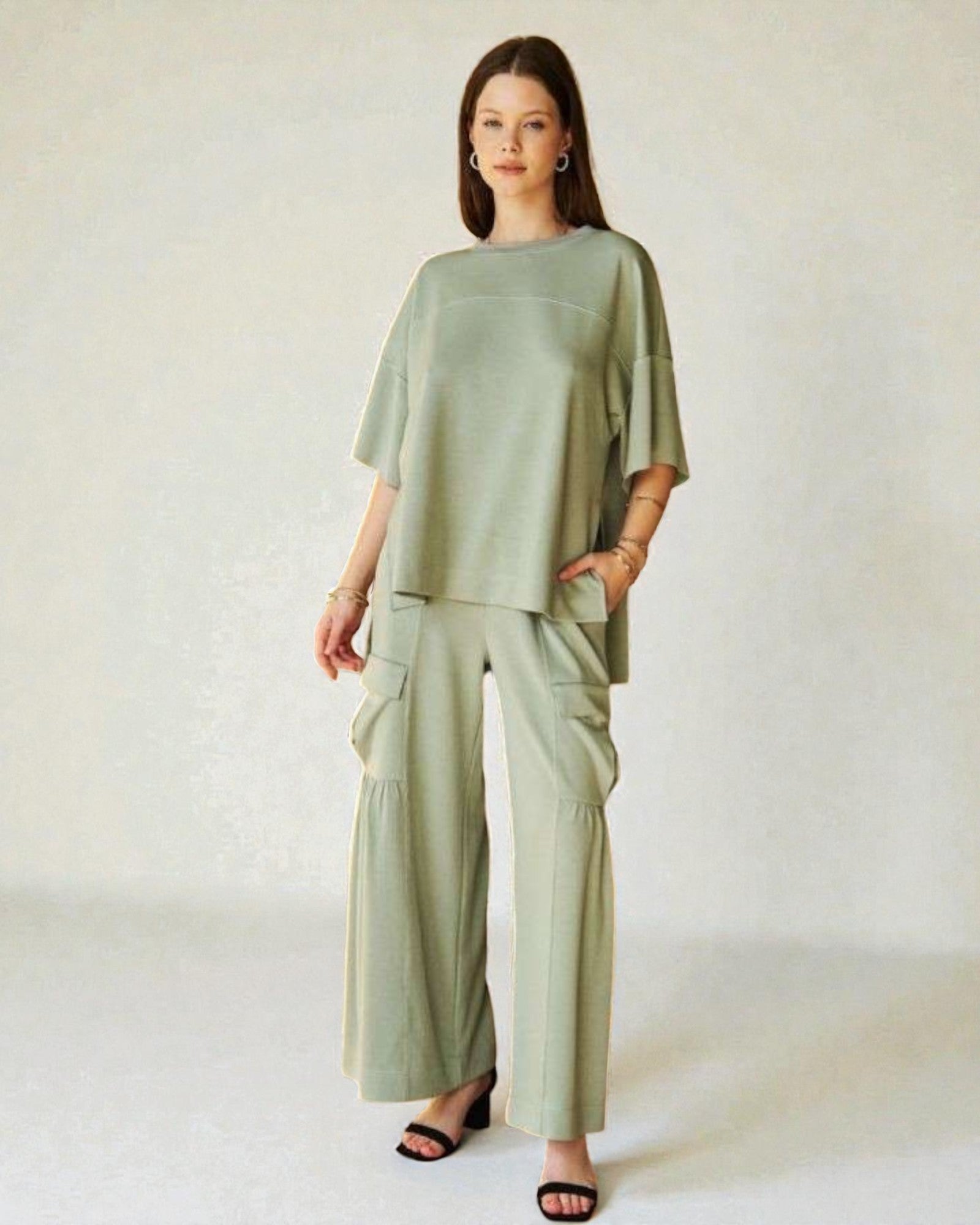 Woman wearing a green outfit on a white background