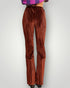 Brown pleated pants on a plain background