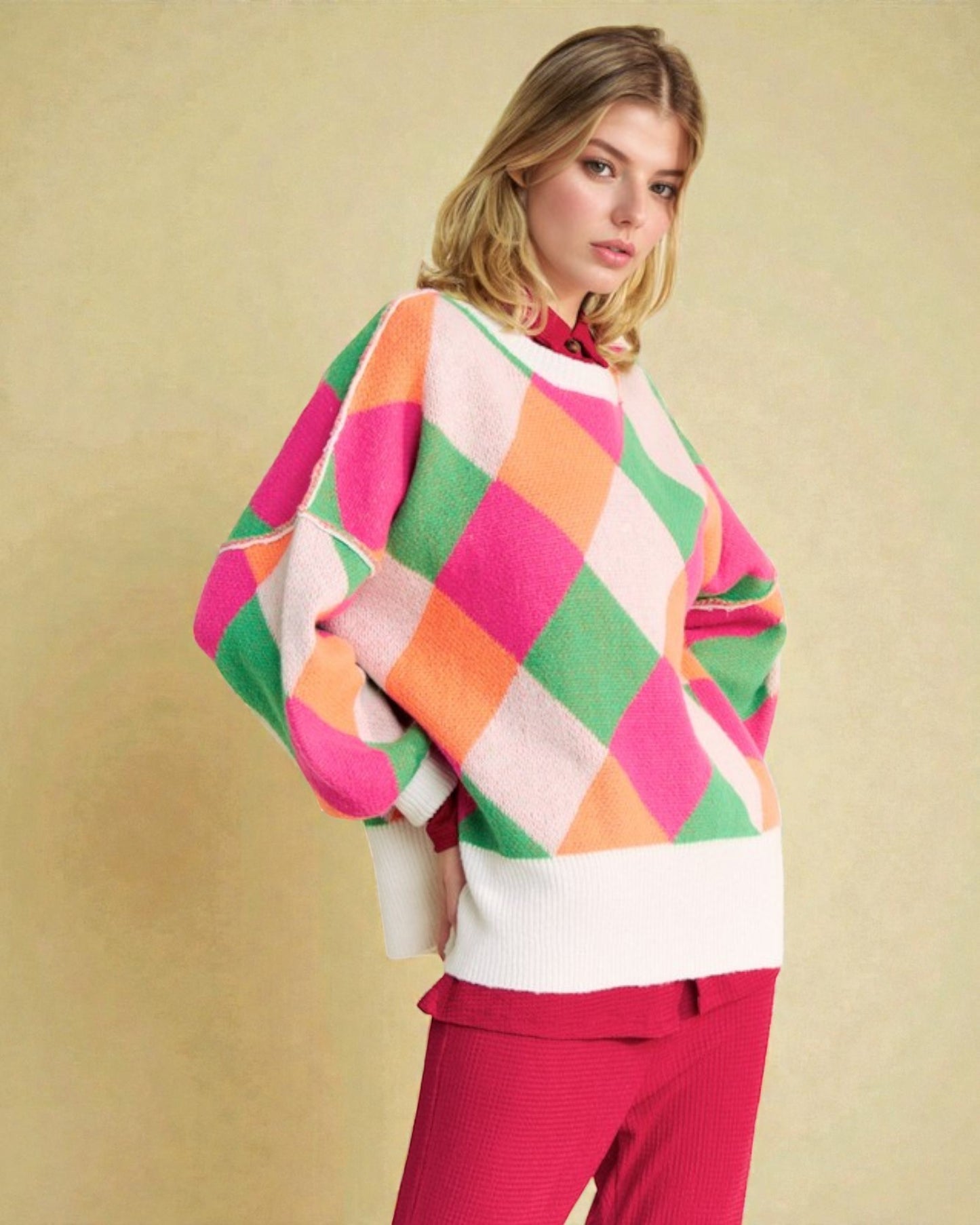 Woman wearing a colorful checkered poncho against a beige background